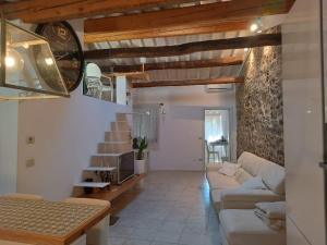 a living room with a couch and a staircase at Il bosco sul Tevere Guest house in Perugia