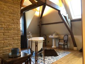 a room with a table and a sink in a building at CLOS DU BAILLI in Saint-Omer