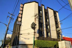 a building with a sign on the side of it at Hotel Princesa in Mexico City
