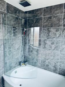 a bathroom with a tub and a shower at Family Room close in Bristol