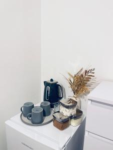 a counter with a tea pot and cups on it at Family Room close in Bristol