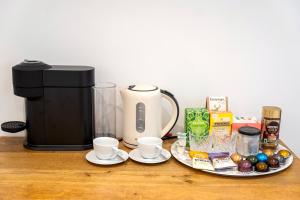 a table with a coffee maker and a plate of food at Soho House in Bordon in Bordon