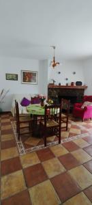 a living room with a table and a piano at Casa Rural Sara in Pinos del Valle