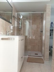 a bathroom with a shower and a sink at Apartamento urb.Basseites in Casas Devesa