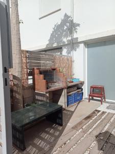 a patio with a bench and a table at Apartamento urb.Basseites in Casas Devesa