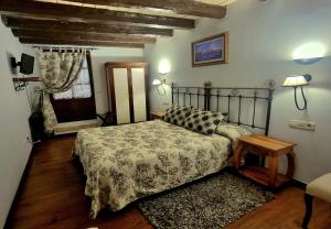 a bedroom with a bed and a table and a window at Casa Rural de Legarda in Briñas