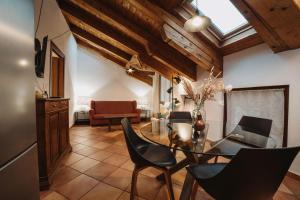 a dining room with a glass table and chairs at Maison Cornalin by Hili in Aosta