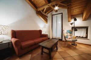 a living room with a couch and a table at Maison Cornalin by Hili in Aosta +7 photos