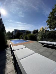 a patio with a bench and a swimming pool at Villa mit pool in Siegburg