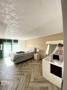 a bedroom with a bed and a wooden floor at Villa mit pool in Siegburg
