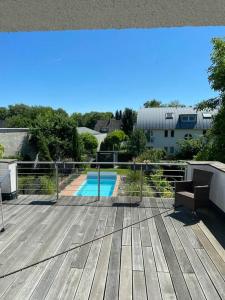a wooden deck with a swimming pool in a yard at Villa mit pool in Siegburg +17 photos