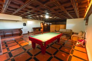 a room with a pool table and a piano at Aparthotel QuintadaCostinha Alijó Douro in Alijó