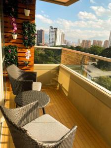 a balcony with chairs and a view of a city at Feel at home in Sabaneta