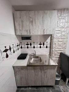 a kitchen with a sink and a counter top at Apartmani River Priboj in Čitluk