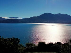 a view of a large body of water with mountains at Appartamento AZZURRO in Cannobio
