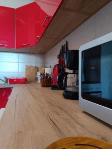 a kitchen with a wooden counter top with a microwave at Apartman Ante in Gospić