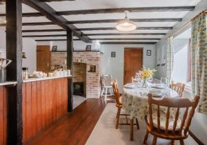 een keuken en eetkamer met een tafel en stoelen bij Granary Cottage in Swimbridge