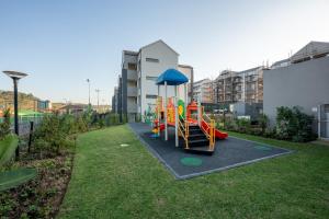 a playground with a slide in a yard at 159 Ballito Village 2 Bedroom Unit in Ballito