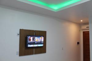a flat screen tv on a wall in a room at Hotel Jardim Tropical in Boa Vista