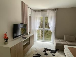 a living room with a couch and a window at Apartmani Berg in Pale
