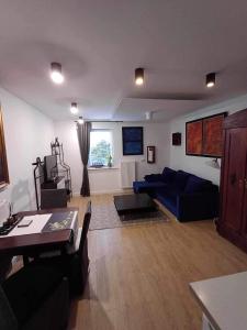 a living room with a blue couch and a table at U Filipa in Gdynia
