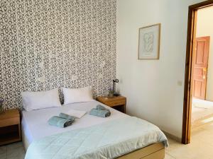 a bedroom with a bed with two pillows on it at Skopelos Inn in Stafylos