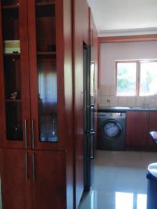 a kitchen with a refrigerator and a washing machine at 21 at Melody in Hartbeespoort