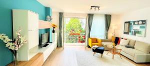 a living room with a couch and a tv at Feel Home DeLuxe CORVIN # FREE PARKING # AC # Elevator in Budapest