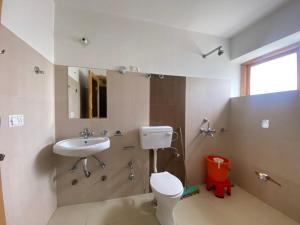 a bathroom with a toilet and a sink at Zaltak Guest House and Hostel in Leh