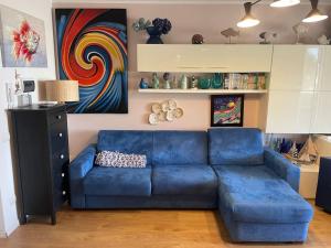 a blue couch sitting in a living room at Mare Fuori in Marina di Grosseto