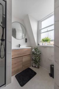a bathroom with a sink and a mirror at Parade Paradise- Secret Views, LEDs, 4K TVs, 5G WIFI and more! in Bath