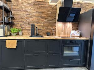 a kitchen with black cabinets and a counter top at A Place To Stay Stavanger, apartment 1 in Stavanger