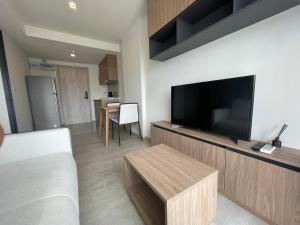 een woonkamer met een flatscreen-tv aan de muur bij Downtown In Huahin la casita in Hua Hin