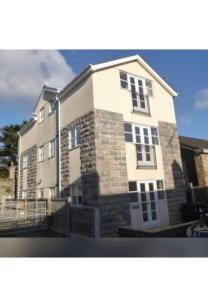 a large white building with windows on a street at Beau retreat lovely apartment in Beaumaris in Beaumaris