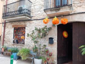 a building with orange decorations on the side of it at Cal Manyo in Puigvert de Lérida