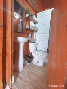 a bathroom with a toilet and a sink at Posada chikiluky beach in Playa Blanca