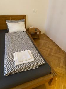 a bed in a room with a wooden floor at Cosy central apartment in Žižkov in Prague