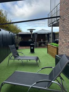 a patio with two chairs and a grill at Appart dans un superbe quartier wierde in Namur