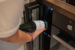 a person is holding a bottle of wine in an oven at Suedseeurlaub2 - Ferienhaus in Otterndorf in Otterndorf