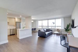 a living room with a couch and a kitchen at Elegance in Crystal City - Amazing Apartment with gym in Arlington