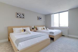 a bedroom with two beds and a large window at Elegance in Crystal City - Amazing Condo with gym in Arlington