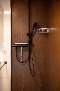 a shower with a shower head in a bathroom at Suedseeurlaub2 - Ferienhaus in Otterndorf in Otterndorf +26 photos
