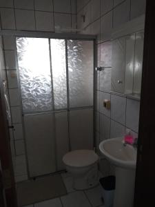 a bathroom with a shower and a toilet and a sink at Apartamento 1 in Florianópolis