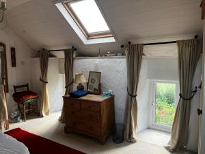 a bedroom with a bed and a window and a dresser at 3 bed cottage in Ahakista West cork in Ahakista