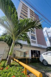 a palm tree in front of a building at Flat 204 Smart Residence Teresina in Teresina