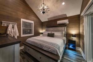 a bedroom with a bed and a chandelier at Romantic getaway in the treetops in Cabot
