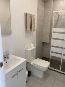 biała łazienka z toaletą i umywalką w obiekcie Alojamientos Plaza Portugal w mieście Sanxenxo