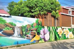 a mural on the side of a building with a waterfall at P'ti Paradise in Le Gosier