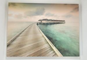 a painting of a pier in the water at P'ti Paradise in Le Gosier