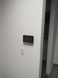 a flat screen tv on a wall in a room at Cataleya - Apartamentos in Marinilla
